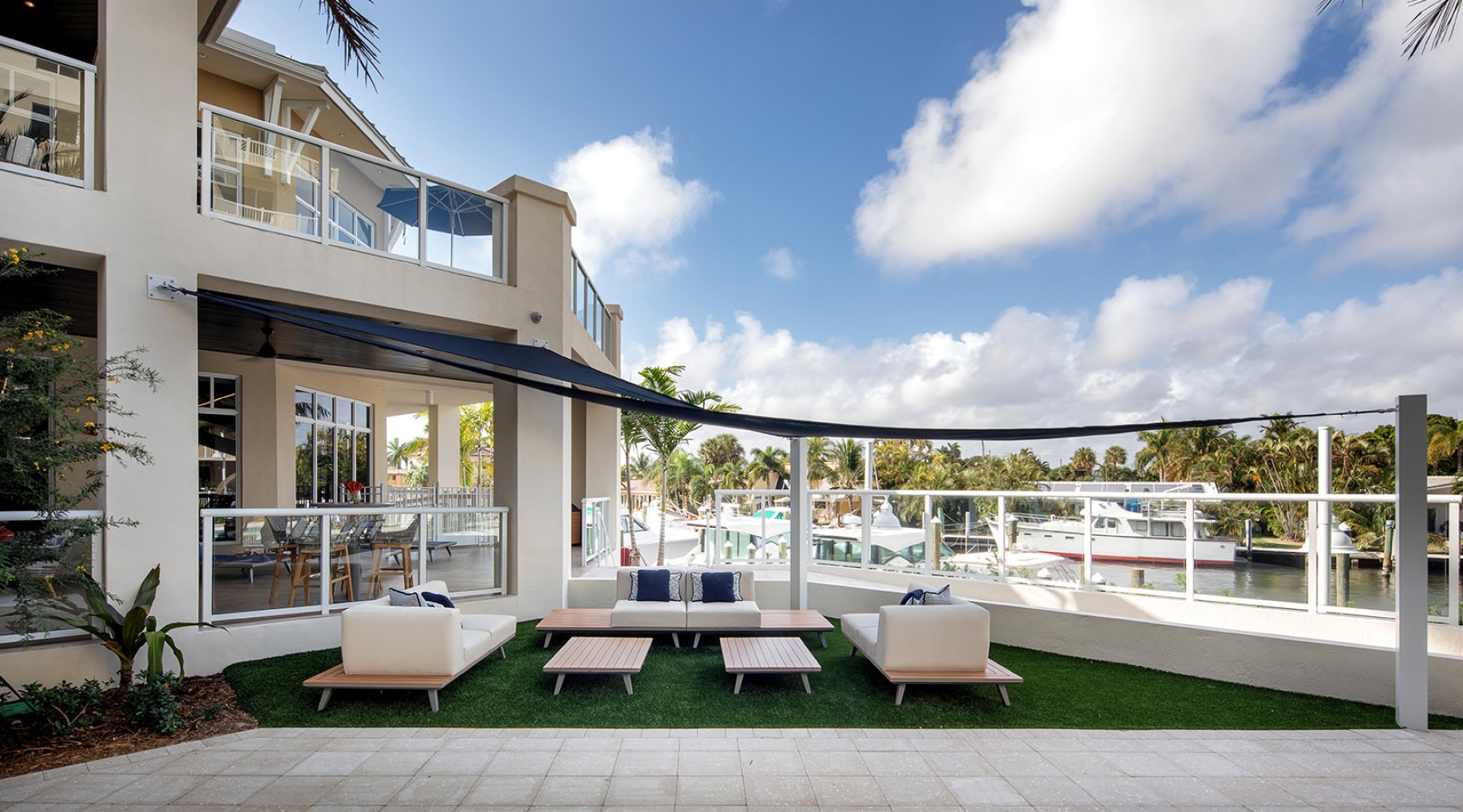 outdoor lounge area near a dock of boats