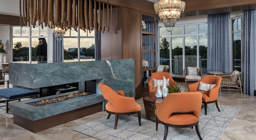 resident common space with modern stone fireplace and seating at 1333 South Ocean apartments in Pompano Beach